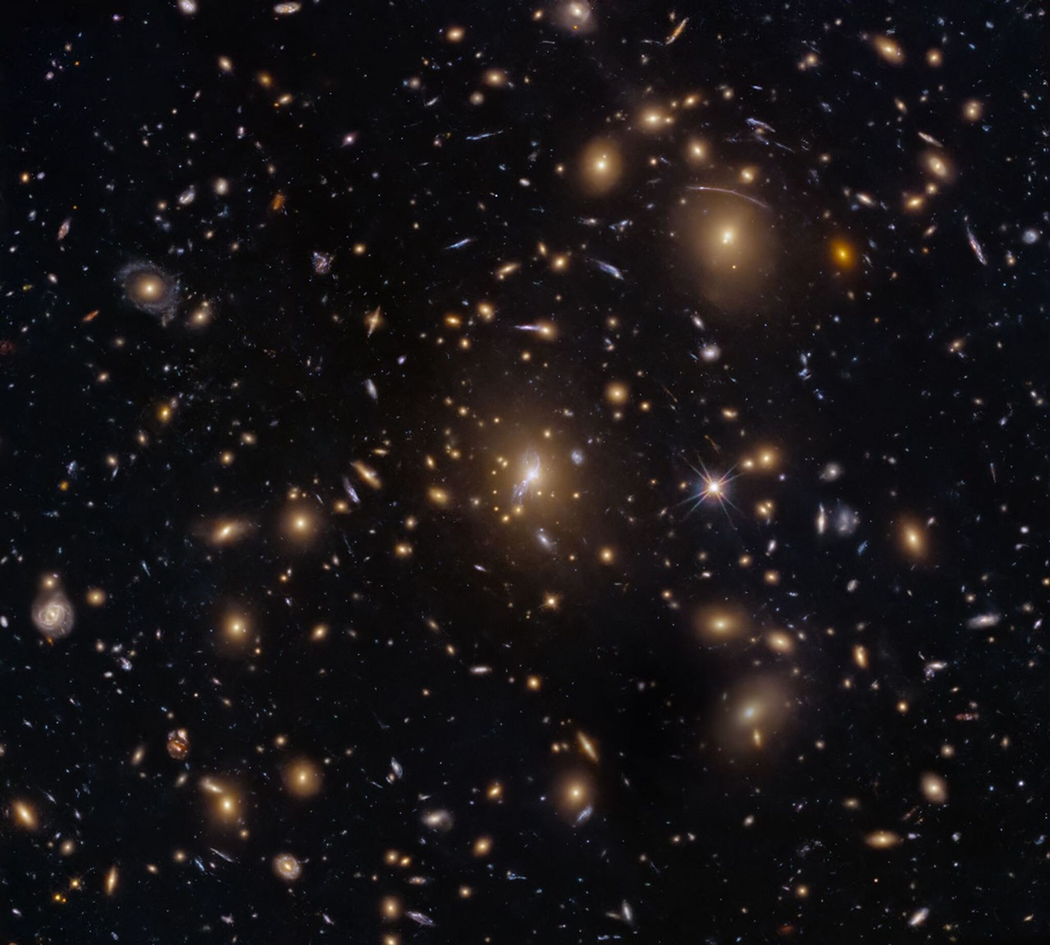 Hubble image shows galaxy cluster bending early-universe light